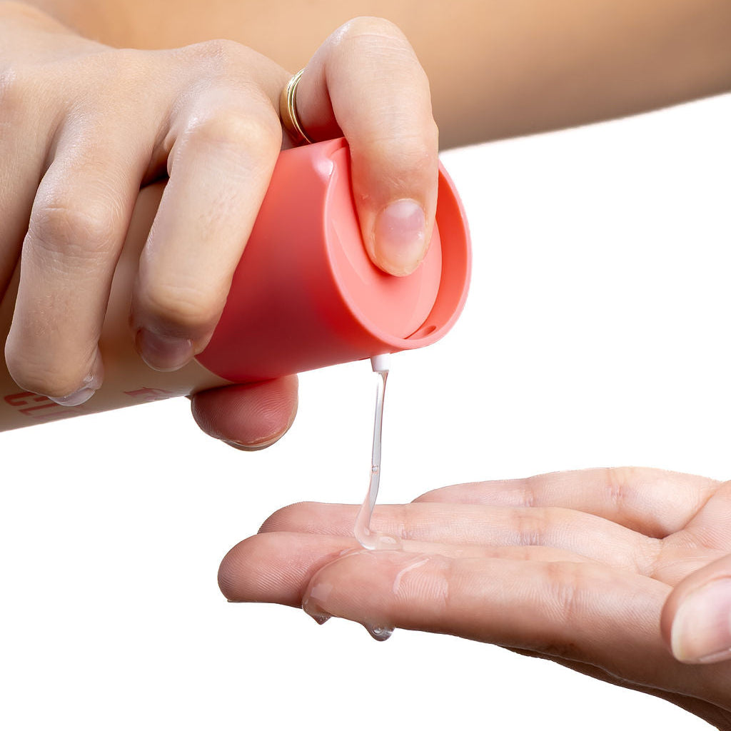 Dew Factor Cleanser gel being pumped from the bottle into a hand