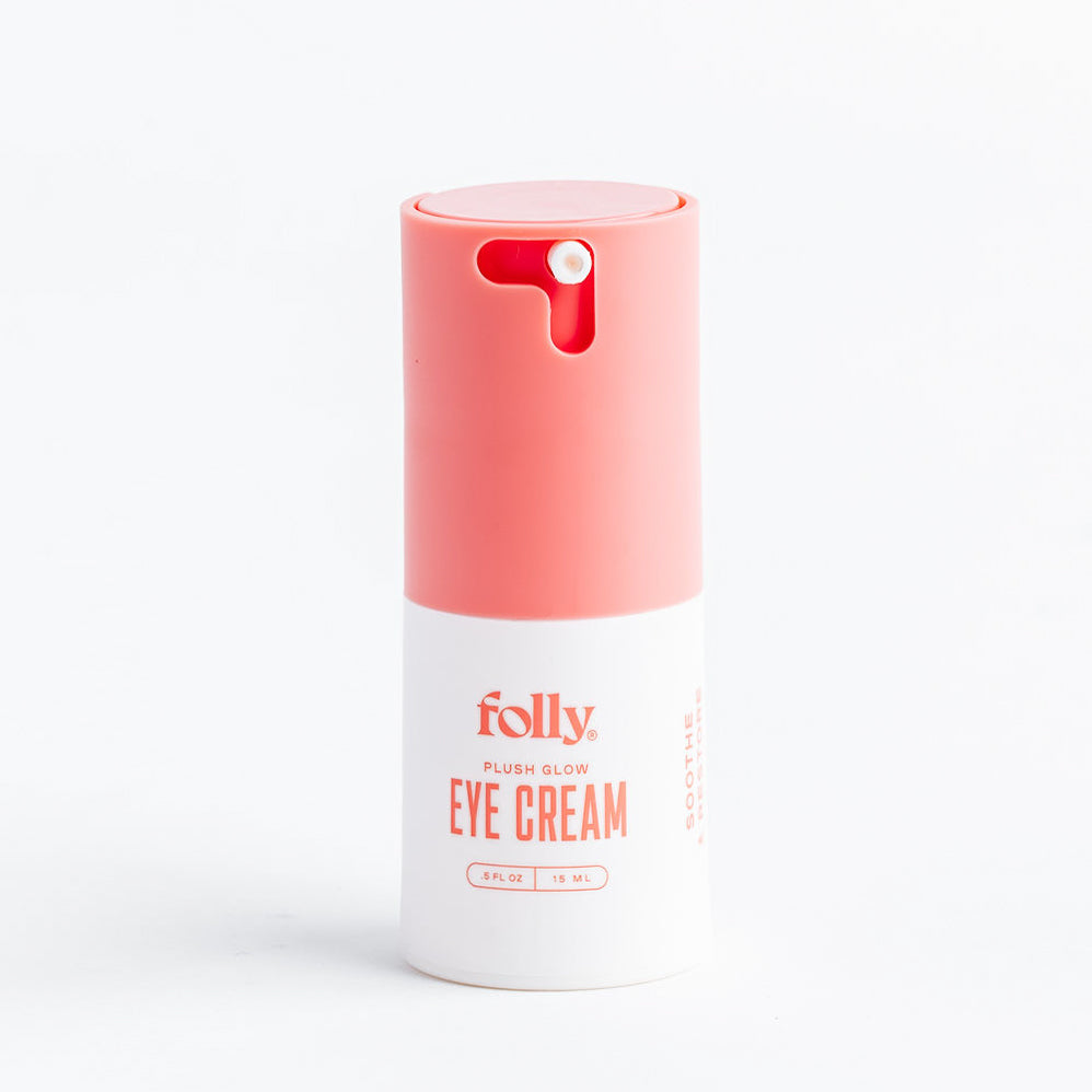 Plush Glow Eye Cream caffeine eye cream in a white and coral pump bottle, Folly Skincare